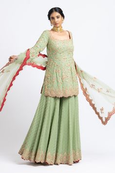 Jade green kurta with floral motifs in gota and bead embroidery. Paired with banarasi woven sharara and embroidered dupatta.
Component: 3
Pattern: Embroidered
Type Of Work: Floral
Neckline: Sweetheart
Sleeve Type: Long Sleeves
Fabric: Georgette, Net
Color: Green
Other Details: 
Tassel detail
Embroidered dupatta
Banarasi woven sharara
Occasion: Wedding - Aza Fashions Unstitched Pista Green Sharara With Dabka Work, Chinon Sharara With Dabka For Reception, Semi-stitched Pista Green Sharara With Dabka Work, Unstitched Pista Green Sharara With Resham Embroidery, Pista Green Semi-stitched Sharara With Dabka Work, Green Chanderi Set For Reception, Green Dola Silk Sharara For Reception, Designer Wear Green Sets With Resham Embroidery, Pista Green Sharara With Resham Embroidery For Eid