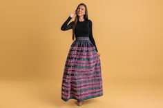 Elevate your wardrobe with our stunning long checks skirt, a perfect blend of classic style and modern flair. Available in two vibrant colors--rich green in a combination with playful pink--this skirt is designed to make a statement wherever you go.  Crafted from high-quality cotton polyester fabric, this skirt offers a comfortable and flattering fit that flows beautifully with every step. The timeless checkered pattern adds a touch of elegance, while the full length provides a graceful silhouet Winter Party Long Maxi Skirt, Winter Party Maxi Skirt, Fall Party Full Maxi Skirt, Winter Party Full Maxi Skirt, Voluminous Maxi Skirt For Fall Party, Fitted Plaid Tiered Skirt, Plaid Tiered Lined Skirt, Plaid Tiered Ruffled Skirt, Fitted Plaid Skirt For Party