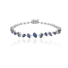 This is part of Chairish’s Fine Jewelry assortment.  This Modern Natural Blue Sapphire Bracelet in 18K gold showcases endlessly sparkling natural blue sapphire of 3.95 carats. It measures 7 inches long in length.  Sapphire stimulates concentration and reduces stress.  Designed with perfect mixed cut blue sapphire set in solid gold to make you stand out on any occasion or event. The elegant style complements the attire beautifully and is a perfect Engagement Gift, Bridal Shower Gift, Valentine Gi Timeless Blue Bracelet For Formal Occasions, Luxury Blue Diamond Bracelet, White Gold Sapphire Tennis Bracelet, Sapphire Tennis Bracelet With Prong Setting, Luxury Sapphire And Diamond Bracelet, Luxury Sapphire Diamond Bracelet With Gemstones, Luxury Sapphire Gemstone Tennis Bracelet, Elegant Blue Marquise Jewelry, Elegant Blue Bracelet With Brilliant Cut