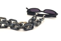 A luxury acetate chain in shades of gray forms this statement glasses necklace for an exclusive appearance. For more ways to wear it, join the closures to get a striking necklace bringing every style to the next level. Nothing less than a stunning accessory! SPECIFICATIONS ‣ European acetate. ‣ Stainless Steel details. ‣ Logo on end. ‣ Grips closure fastening. ‣ Width: 40mm. ‣ Lenght: 70cm (27''). ‣ Includes a pair of black and clear rubber loops. ‣ Packed in a custom eco box. BENEFITS ‣ Premium Chunky Glasses, Resin Chain, Eyewear Chain, Tortoise Shell Glasses, Eyeglass Strap, Sunglasses Holder, Sunglasses Strap, Steel Detail, Chic Necklace