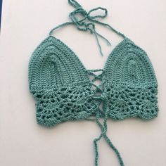 This top will best fit a size xsmall/small. It was made with soft acrylic worsted weight yarn. It ties around the neck as well as behind the back & has one tie criss crossing in the middle of the chest - which can be tied any way & loosens and tightens the top as well. Green Knit Crochet Beach Top, Green Knit Crochet Top For The Beach, Beach Crochet Knit Top In Green, Beach Knit Fitted Halter Top, Beach Fitted Knit Halter Top, Fitted Knit Halter Top For The Beach, Fitted Open Knit Crop Top For Vacation, Green Fitted Crochet Top, Fitted Bohemian Crochet Cotton Top