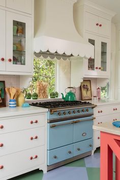 a kitchen with an oven, stove and cabinets in it's center island area