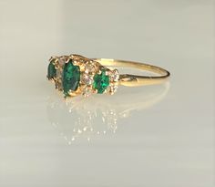 Marquise Emerald Ring, Emerald Diamond Ring, Dainty Emerald Ring, Emerald Ring for Women, Vintage Emerald Ring, Three Stone Emerald Ring A delightful vintage three stone ring featuring three deep green marquise shaped emeralds weighing 0.52 carats accented by 0.21 carats of sparkling white diamonds set in solid 14k yellow gold. Vintage Emerald Ring, Green Engagement Rings, Antique Emerald Ring, Vintage Emerald Engagement Ring, Emerald Ring Vintage, Ring Three Stone, Cute Engagement Rings, Mom Ring, Bohemian Jewellery