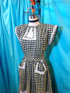 "1940s W:25 black yellow white cotton plaid eyelet contrast short sleeve tie keyhole neckline button back hip pocket A-line skirt day dress. This features a black/yellow/white cotton plaid base, white cotton eyelet contrast, unlined interior, short sleeves, large shoulder pads, neckline gathers, tie keyhole neckline, gathered bust, fitted waistband, bow details, double hip pockets, gathered A-line skirt, clear lucite buttons, and button up back closure! MEASUREMENTS Bust: 36\" Waist: 25\" Hips: Retro Short Sleeve Plaid Gingham Dress, Vintage Gingham Dress With Short Sleeves, Vintage Style Gingham Plaid Short Sleeve Dress, Vintage Plaid Short Sleeve Dress, Vintage Gingham Plaid Dress With Short Sleeves, Retro Short Sleeve Plaid Dress, Retro Plaid Dress For Daywear, Vintage Short Sleeve Plaid Cotton Dress, 40s Dresses