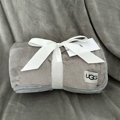 the ugg blanket is wrapped in white ribbon