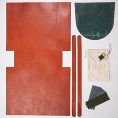 an assortment of leathers and accessories laid out on a table