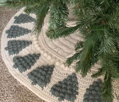 a crocheted christmas tree skirt with pine needles