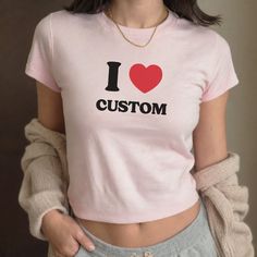 Embrace the 90s revival with our custom baby tee, featuring personalized text options that let you express yourself uniquely and stylishly. It's the perfect way to add a nostalgic touch to your wardrobe while making a bold statement. ⭐️ WELCOME TO COZY CREATIONS ⭐️ Hey there, welcome to our shop. We're your go-to spot for super comfy and awesome apparel! We're all about spreading good vibes and making your shopping experience a fun and easy. If you've got any questions, concerns, or just want to say hey, shoot us a message anytime. We'll try to get back to you as quickly as possible. Happy shopping! 🛒 HOW TO ORDER  1-) Please, check and review all photos 2-) Choose your t-shirt size and color 3-) Enter your custom text exactly how you would like it spelled out (e.g. I heart DOGS) 4-) Spec Pink Y2k Tops With Custom Print, Pink Y2k Style Top With Custom Print, Y2k Pink Top With Custom Print, Customizable Cute Crew Neck Tops, Customizable Cute Cotton Tops, Y2k Crew Neck T-shirt With Custom Print, Y2k Custom Print Crew Neck T-shirt, Customizable Summer Streetwear T-shirt, Fitted Pink T-shirt With Name Print