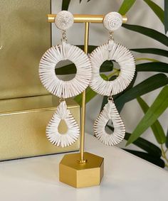 Our Moon River Raffia Wrapped Circle And Teardrop Earrings are a beautiful and unique accessory that will add a touch of bohemian style to any outfit. These earrings feature a stunning combination of circular and teardrop shapes wrapped in ivory raffia, creating a textured and interesting look.
Expertly crafted with attention to detail, these earrings feature post backs that provide a secure and comfortable fit. At 4.25 inches long, they dangle gracefully from your ears, adding movement and dime Bohemian White Tassel Earrings For Pierced Ears, White Teardrop Earrings, White Bohemian Teardrop Earrings For Pierced Ears, White Bohemian Teardrop Earrings, Summer Beach Teardrop Earrings, Handmade Bohemian Teardrop Earrings For Beach, Bohemian Handmade Teardrop Earrings For Beach, Bohemian Dangle Teardrop Earrings For The Beach, Handmade Bohemian Teardrop Earrings For Summer