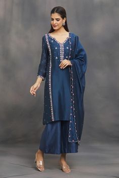 Classic blue kurta with aari, bead, sequin, thread embroidery in floral pattern. Paired with flared pant and dupatta.
Components: 3
Pattern: Embroidery
Type Of Work: Aari, bead, sequin, thread
Neckline: Notched
Sleeve Type: Long sleeves
Fabric: Chanderi
Color: Blue
Other Details: 
Scallop bordered dupatta
Occasion: Puja - Aza Fashions Blue Kurta, Kurta Set For Women, Women Kurta, Straight Kurta, Pattern Embroidery, Thread Embroidery, Kurta Set, Set Women, Classic Blue