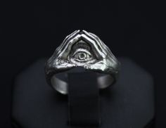 EYE OF PROVIDENCE RING * The Eye of Providence represents divine watchfulness and care of the universe. This century old symbol continues to grow in meaning over time, but is generally recognized as the eye of God watching over humanity * Arrives in gift ready packaging MATERIALS * Sterling Silver plated Zamak. (zamak is a mix alloy of zinc, aluminum, magnesium and copper) * Hypoallergenic! Designed to cater to sensitive skin, nickel & lead free MEASUREMENTS * Adjustable, will fit different ring The Eye Of Providence, Freemason Ring, Eye Of God, Eye Of Providence, Old Symbols, Eye Eye, Triangle Ring, Seeing Eye, All Seeing Eye