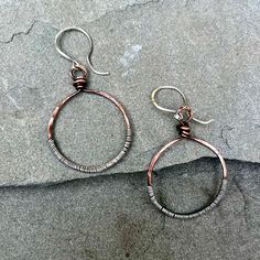 These lovely copper circle earrings have been textirized and patina'ed and the wrapped in sterling silver wire for a unique, artisan look to them.  They are hung on handmade, artisan sterling silver earwires and measure about 2 inches long. Copper And Silver Jewelry, Artisan Copper Hoop Earrings Nickel Free, Artisan Nickel Free Copper Hoop Earrings, Artisan Electroformed Hoop Earrings, Adjustable Soldered Hoop Earrings For Gifts, Adjustable Circular Copper Jewelry, Silver Copper Wrap Earrings Gift, Handmade Copper Round Hoop Earrings, Copper Wire Wrapped Round Hoop Earrings