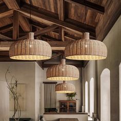 a dining room with wooden tables and hanging lights over it's table top area