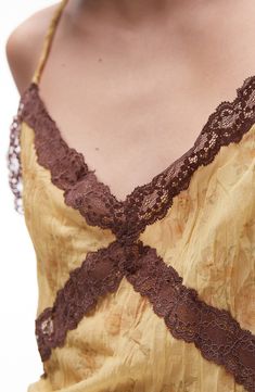 Romantic lace levels up the flirty style of this silky camisole that has a subtly crinkly texture. 12" length (size Medium) V-neck 100% polyester Machine wash, line dry Imported Spring V-neck Slip Dress With Contrast Lace, Lace V-neck Camisole, Feminine Lace V-neck Camisole, Spring Cami Lace Top With Contrast Lace, Daywear Camisole With Contrast Lace And Spaghetti Straps, Summer V-neck Slip Dress With Contrast Lace, Summer Cami Slip Dress With Delicate Lace, Summer Lace Camisole With Contrast Lace, Sleeveless Summer Camisole With Contrast Lace