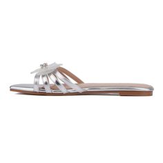 Embrace the beauty of spring with the Shayla sandal, featuring the prettiest floral accents that bloom elegantly across the strappy design. This charming flat sandal is crafted for effortless style, with a convenient slide silhouette that makes it perfect for weekends and beyond. Whether you're heading to brunch or a casual outing, the Shayla sandal adds a touch of whimsy to any outfit. Comfortable and fashionable, it's the ideal choice for those who love to express their feminine flair. Open Toe Flats For Summer Weddings, Open Toe Summer Wedding Flats, Summer Wedding Open Toe Flats, Spring Silver Flat Heel Sandals, Silver Flat Sandals For Spring, Flat Sandals For Spring Wedding, Adjustable Flower Sandals For Spring, Elegant Beach Flats For Spring, Elegant Spring Beach Flats