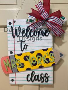 a welcome sign hanging from the front door to someones class or class room in new york