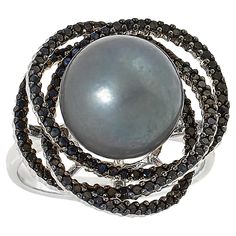 Kwan Collections Sterling Silver Tahitian Pearl and Black Spinel Ring  A shimmering black Tahitian pearl paired with the diamond-like sparkle of black spinel and fashioned into a beautiful, modern ring design, makes an elegant addition to any accessories collection.       Approx. 3/4"L x 13/16"W x 9/16"H; shank 1/16"W     Stamped .925; rhodium plating     Sterling silver ring has 11-12mm off-round black pearl at center of open frame comprised of overlapping hoops     Frame lined with round, blac Elegant Black Rings With Gemstone Accents, Formal Black Tahitian Pearl Jewelry, Black Tahitian Pearl Fine Jewelry, Elegant Black Multi-stone Jewelry, Black Tahitian Pearl Ring, Black Tahitian Pearl Jewelry For Anniversary, Formal Black Tahitian Pearl Ring, Anniversary Black Tahitian Pearl Jewelry, Black Pearl Ring In Fine Jewelry Style