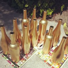 there are many vases that are on the table together, and one is gold