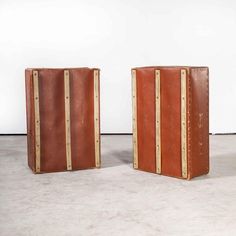 two pieces of luggage sitting side by side on the floor in front of a white wall