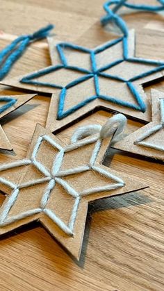 some cut out snowflakes sitting on top of a wooden table