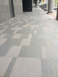 an empty sidewalk in front of a building