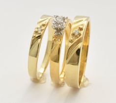 two yellow gold wedding rings with diamonds on each one, set against a white background