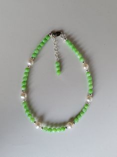 This anklet is mainly made of mint green colored Mother-of-Pearl, Sterling Silver, and Freshwater Pearl beads. The anklet has a 1" beaded extension making it adjustable.  Custom Orders are always welcome! Ask about free sizing. Green Beaded Anklets With Round Beads, Elegant Green Anklet For Gifts, Elegant Green Anklets For Gift, Green Pearl Beaded Bracelets, Green Beaded Pearl Bracelet, Providence Ri, Green Mint, White Freshwater Pearl, Anklet Jewelry