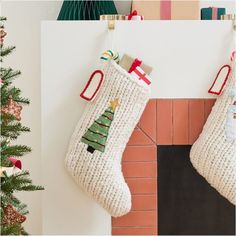 two christmas stockings hanging from a fireplace