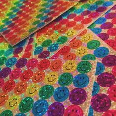 rainbow sequinized smiley face stickers on top of each other in different colors