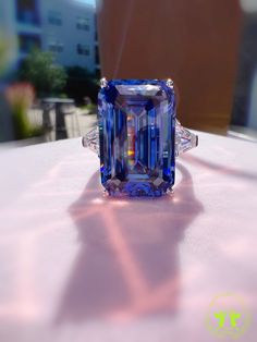 29 Carat Emerald Cut Three Stone ROYAL Blue SAPPHIRE Simulant Ring Fabulous Anniversary Engagement Ring S925/14K/18K The Mainstone size is 13*20mm (29 Carat) Made to order ♥925 SILVER WITH 18KGP ♥ The main stone is the finest Lab-Grown Sapphire  ♥Absolutely gorgeous and beautifully handcrafted Lab-Grown Sapphire Ring in solid 925 Sterling Silver. ♥ This classic yet trendy Ring makes the perfect Christmas/Anniversary/Valentine's/Birthday gift for her that will be treasured forever. We have confid Exquisite Blue Diamond Ring Gift, Exquisite Blue Diamond Ring For Gift, Blue Gia Certified Emerald Ring For Formal Occasions, Blue Tanzanite Topaz Ring For Anniversary, Blue Emerald Anniversary Ring In Fine Jewelry Style, Exquisite Tanzanite Blue Rings, Luxury Blue Emerald Ring For Wedding, Gia Certified Blue Topaz Ring As Gift, Exquisite Blue Tanzanite Ring