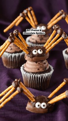 cupcakes with chocolate frosting and googly eyes are on a purple cloth