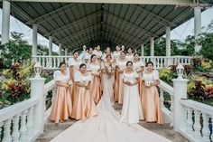 a group of women standing next to each other in front of a white gazebo