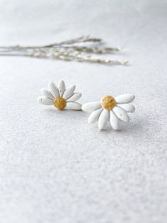 Half DAISY flower stud earrings | Floral, Spring collection | Handmade, cute gift | Polymer Clay | Nickel free | Minimalist, Yellow earrings These half daisy studs can really uplift your mood. The shape looks gorgeous on the ear, works well with both neutral and bright outfits. More styles available on my shop. If you have a more specific request, please get in touch and I'll be happy to custom make your pair. Like every piece in my shop, these studs are handmade with care by me, so please allow Trendy Handmade White Flower Earrings, Trendy White Handmade Flower Earrings, Tiny White Dainty Flower Earrings, White Minimalist Jewelry, Dainty White Birth Flower Earrings, Minimalist Small White Jewelry, Tiny White Earrings For Gift, White Flower Charm Earrings For Everyday, Small White Earrings For Gift