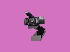 a black camera on a purple background