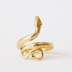 In front of a white background is a gold snake ring. The tail is at the bottom and the body and head curves around to the top of the ring. Ancient Crete, Serpent Ring, The Serpent, Notes Gift, The Dawn, Crete, Modern Jewelry, Fertility, Rose Gold Ring