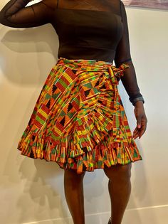 Relax in the beauty of African history with our stunning Kente wrap skirt. Crafted from the finest Kente fabric, this masterpiece has complex designs and brilliant colours that represent grandeur and prestige. Whether you like the classic beauty of a maxi, the whimsical appeal of a mini, or the elegant allure of a midi, our Kente wrap skirts are a tribute to African culture. The wrap design flatters every form, and the sumptuous Kente fabric drapes elegantly. Elevate your wardrobe with this striking item that flawlessly combines heritage and current design. Experience the beauty of Kente and create a striking fashion statement. Features:  ✨Kente fabric, wrap style, versatile length options, handcrafted details. ✨Perfect for Special occasions, cultural events, and evening wear. ✨Pair with a Fitted Multicolor Ruffled Mini Skirt, Traditional Long Skirt With Ruffles, Multicolor Fitted Long Wrap Skirt, Traditional Fitted Tiered Skirt, Traditional Tiered Ruffle Skirt, Fitted Multicolor Tiered Skirt, Bohemian Fitted Mini Skirt With Gathered Details, Fitted Bohemian Pleated Mini Skirt, Fitted Bohemian Mini Skirt With Gathered Detail