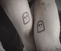 two people with matching tattoos on their arms, one has a ghost and the other has a ghost