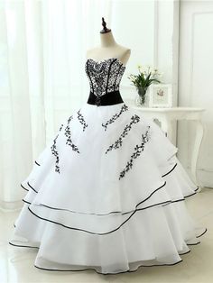 a white and black wedding dress on a mannequin