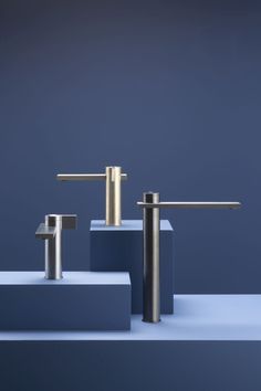 three different types of faucets sitting on top of each other in front of a blue background