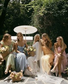 the bridesmaids are all dressed in pastel dresses