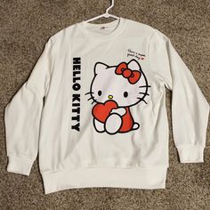 This Hello Kitty Sweatshirt Is Positively Adorable! It Features A Full-Length Hello Kitty Sitting With A Big Red Heart. Above Her Is The Saying “Have A Super Great Day.” It Also Says Hello Kitty Running Down The Side Of The Front Of The Sweatshirt. It Is A One Size Fitted Sweatshirt. I Am 36c In The Bust Area And It Fits Me Big. It Has Never Been Worn! Hello Kitty Streetwear, White Kawaii Crew Neck Top, White Casual Sweatshirt With Cat Print, Casual White Sweatshirt With Cat Print, White Kawaii Sweatshirt With Graphic Print, White Crew Neck Sweatshirt With Cat Print, White Long Sleeve Sweatshirt With Cat Print, Red Hello Kitty Print Crew Neck Top, Red Crew Neck Top With Hello Kitty Print