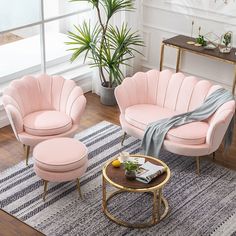 a living room with pink chairs and a round coffee table