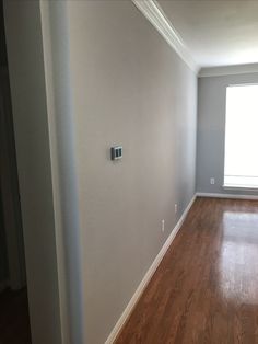 an empty room with hard wood floors and white paint on the walls is seen in this image