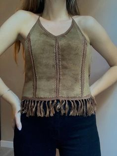 Pocahontas suede leather halter top  Perfect festival top  Very soft nice leather  Vintage  Made by Apart Size  L modeled on M Zipper on back  100% leather  Very good vintage condition, no marks or holes  Between underarms 52cm 20,5" Length without halter and fringes 39cm 15,2" Brown Fringed Tops For Festival, Brown Bohemian Sleeveless Crop Top, Fringe Leather Vest, Brown Leather Fringe Shoulder Bag, Leather Halter Top, Bohemian Leather Shoulder Bag With Fringe, Boho Fringe, Leather Halter, Festival Tops