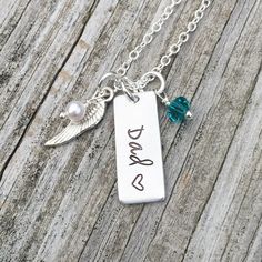 This beautiful necklace is the perfect way to remember a loved one. Silver necklace comes with an aluminum tag hand stamped with your loved one's name and a heart stamped after the name, a genuine Swarovski crystal birthstone charm, an angel wing charm, and a Swarovski pearl. Also available in sets of 2 or more at a discounted price. My items are hand stamped by me, making them a unique gift. Each letter is stamped individually and may not line up exactly adding to the charm and uniqueness of th Personalized Dog Tag Charm Necklaces For Anniversary, Personalized Dog Tag Charm Necklace For Anniversary, Mother's Day Hand Stamped Dog Tag Jewelry, Hand Stamped Sterling Silver Necklaces For Father's Day, Personalized Hand Stamped Dog Tag Jewelry, Adjustable Stainless Steel Charm Necklace For Anniversary, Father's Day Hand Stamped Dog Tag Necklaces, Father's Day Hand Stamped Dog Tag Necklace, Adjustable Hand Stamped Necklaces For Father's Day