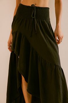 So billowy and ethereal, this stunning maxi skirt from our free-est collection will turn heads all season long. **Fit:** High-rise, billowy asymmetrical silhouette **Features:** Wide smocked waistband, drawstring feature, tiered design **Why We ❤ It:** Sleek with a simple tube top or laid back with a baby tee, this style has endless ways to wear. | Island Girl Maxi Skirt by free-est at Free People in Black, Size: S Beach Maxi Skirt With Gathered Detail, Beach-style Gathered Maxi Skirt, Breezy Beach Maxi Skirt With Ruffles, Breezy Ruffled Maxi Skirt For Beach, Breezy Ruffled Maxi Skirt For Vacation, Summer Ruched Asymmetrical Maxi Skirt, Flowy Asymmetrical Skirt Dress With Ruffle Hem, Spring Tiered Maxi Dress With Gathered Skirt, Asymmetrical Skirt Dress With Ruffle Hem And Flowy Fit