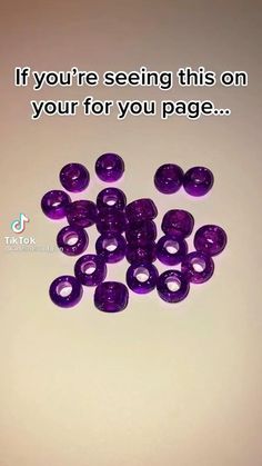 a bunch of purple buttons sitting on top of a table