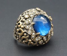 I am offering you beautiful Turkish ottoman sterling silver & Bronze ring. Beautiful glass zircon beads design. Please do not hesitate to contact if you have any questions. Weight : 29.2 grams,  Ring size 7.5 on US Jewelry ring mandrel  Shipping & Estimated Delivery Time With Turkish Registered Post, Destination CountryStandard Shipping (business days) United States 15-20  Europe7-15 Asia15-25  Australia15-20 Brazil & South America Silver Jeweled Promise Ring, Silver Jeweled Rings Made Of Cubic Zirconia, Silver Jeweled Cubic Zirconia Rings, Silver Jeweled Ring For Anniversary, Silver Jeweled Rings With Cubic Zirconia, Blue Jeweled Rings For Gifts, Blue Jeweled Rings For Gift, Jeweled Rings As Gifts, Topaz Stone Ring Gift