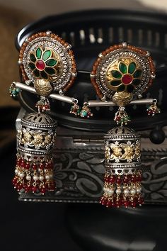 92.5 silver toned carved jhumka earrings embellished with green kundan stones and red, white pearl and beads. - Aza Fashions Navratri Ceremonial Tilla Danglers, Tilla Danglers For Ceremonial Navratri, Traditional Oxidized Jhumkas For Diwali, Ornate Meenakari Chandbalis For Festivals, Festive Fusion Earrings With Oxidized Finish, Festive Dual-tone Fusion Danglers, Festive Fusion Dual-tone Danglers, Ornate Jhumkas Drop Earrings With Latkans, Traditional Oxidized Finish Jhumkas Drop Earrings