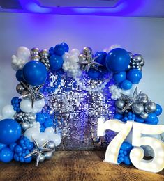 an arch made out of blue and silver balloons